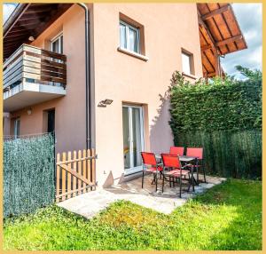 a table and chairs in front of a house at Appartement Le Blansin in Saint Pierre en Faucigny