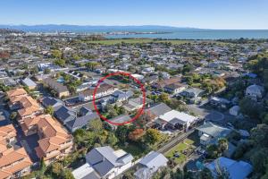 an aerial view of a suburb with a red house at Villa Cambria in Nelson