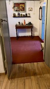 a room with a red carpet and a table at Traditional Detached House in Spetses