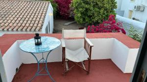 a table and a chair sitting next to a glass table at Traditional Detached House in Spetses