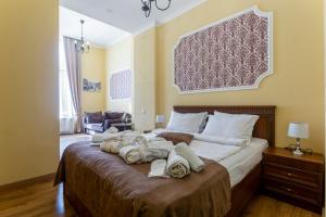 a bedroom with a large bed with towels on it at Hotel Middleton in Tbilisi City