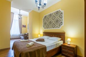 a bedroom with a large bed with yellow walls at Hotel Middleton in Tbilisi City