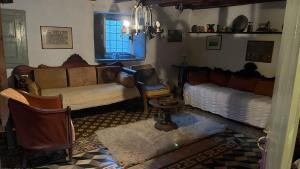 a living room with two beds and a window at Traditional Detached House in Spetses