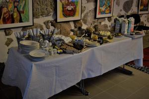 a table with plates and food on top of it at Lilla Rygårdens B&B in Lövestad
