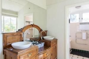 a bathroom with two sinks and a large mirror at Elevated Serenity - Where Views Meet Comfort in Katoomba