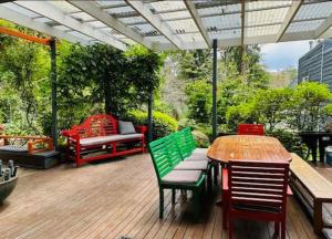 a patio with a table and chairs and a bench at Elevated Serenity - Where Views Meet Comfort in Katoomba