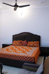 a bed with pillows on it in a room at Mohal's House in Lahore