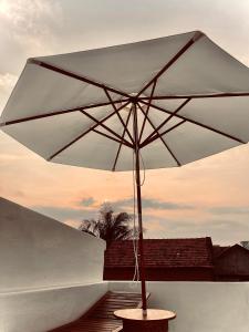 a white umbrella sitting on top of a table at Lo Villa - Venuestay in Phu Yen
