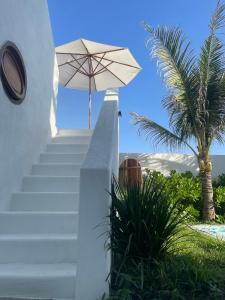 a staircase with an umbrella and a palm tree at Lo Villa - Venuestay in Phu Yen