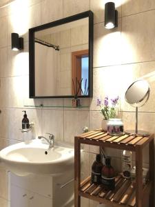 a bathroom with a sink and a mirror at Feel Like Home @Strakova, Very central luxury APT in Bratislava +28 photos