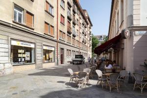 a street with tables and chairs on a street with buildings at Feel Like Home @Strakova, Very central luxury APT in Bratislava