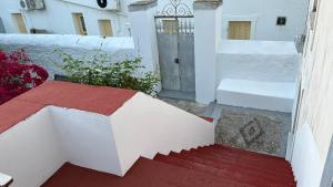 a stairway leading to a white building with a door at Traditional Detached House in Spetses
