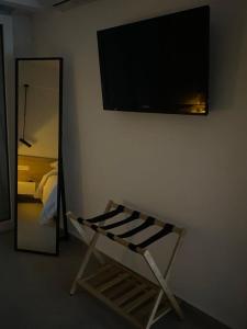 a room with a flat screen tv on a wall at Miliannas in Athens