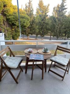a patio with two chairs and a table and a table and chairs at Miliannas in Athens