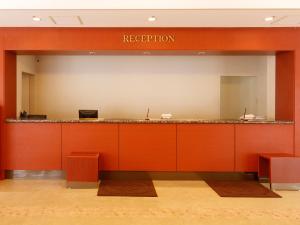 a hotel lobby with a reception counter with arippleton sign at Hotel Pearl City Akita Kanto-Odori in Akita