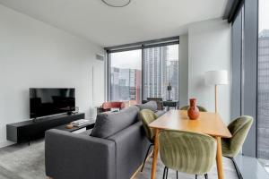 a living room with a couch and a table at Blueground Downtown pool lounge gym nr shops ATX-257 in Austin