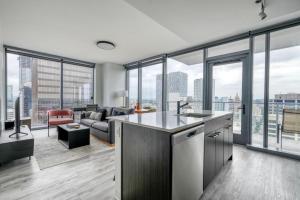 an open kitchen and living room with large windows at Blueground Downtown pool lounge gym nr shops ATX-257 in Austin