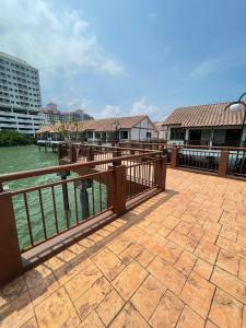 a balcony with a fence and a body of water at Cuti-cuti port dickson water chalet in Port Dickson