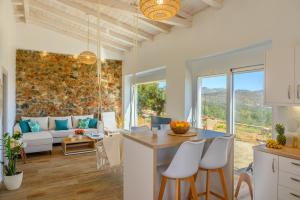 a kitchen and living room with a table and chairs at Althea Villas by breathtaking view in Agios Nikolaos