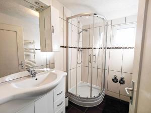 a white bathroom with a sink and a shower at Monteurhaus in Heidenheim in Heidenheim an der Brenz