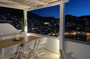 a table and chairs on a balcony with a view at Villa Sunset Signature - Private Pool & Sea View in Hydra