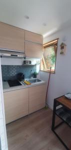a small kitchen with a sink and a window at CozyCube Paris in Vitry-sur-Seine