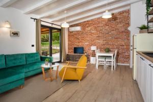 a living room with a green couch and a table at Garden House Rovinj in Rovinj