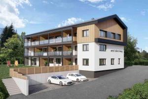two cars parked in front of a building at West shore Appartement in Faak am See