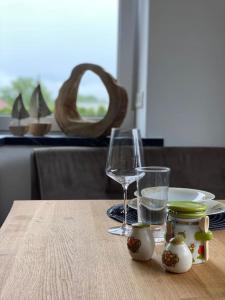 a table with a glass of water and a plate of food at West shore Appartement in Faak am See +18 photos