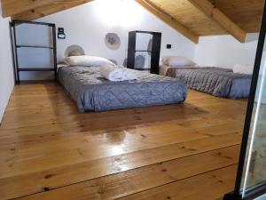 Habitación con 2 camas y suelo de madera. en Fontana Leone, en Spílion