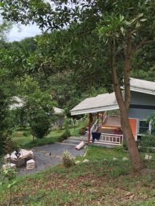 a house with a porch and a tree at Bangnu Greenery Resort in Takua Thung