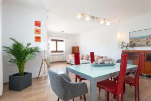 a living room with a blue table and chairs at Can Joan -Maria- in Maria de la Salut