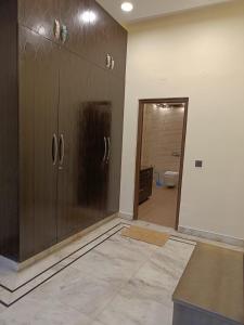 a kitchen with a large wooden cabinet in a room at Homestay in Connaught Place in New Delhi