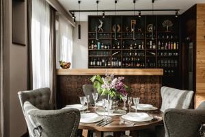 a dining room with a table and chairs at ARIETES MARMONT Resort TINY Houses in Tatranska Strba