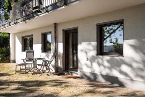 a table and chairs sitting outside of a house at Biloba Garden in Wengern