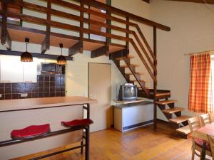 a room with a kitchen and a staircase with a microwave at Cosy holiday home in the Hochsauerland with terrace at the edge of the forest in Schmallenberg