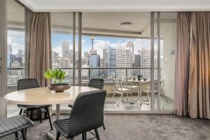 een eetkamer met een tafel en een groot raam bij DREAM HARBOUR VIEW 2 BRM // GYM, POOL and PARKING in Sydney