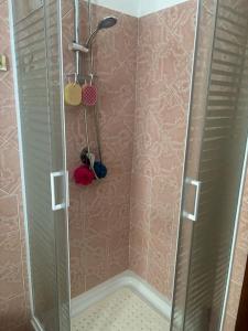a shower with a glass door in a bathroom at Villetta con Giardino in Salerno
