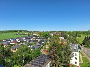 an aerial view of a suburb with solar panels on roofs at Hotelak Martinov in Ostrava
