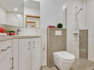 a white bathroom with a toilet and a shower at Spacious Apartment in Madfeld with Private Terrace in Madfeld