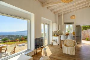 a living room with a large sliding glass door at Althea Villa by breathtaking view in Agios Nikolaos