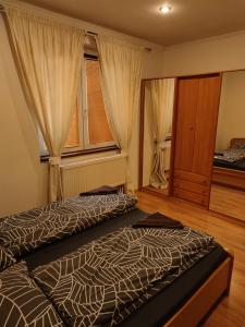 1 Schlafzimmer mit 2 Betten und einem Fenster in der Unterkunft Apartment in the centrum with free private parking in Levice