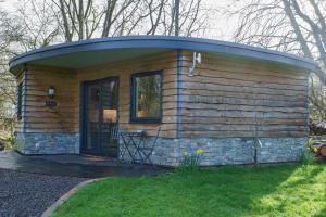 a small log cabin with a round roof at Conkers - a new bespoke rural escape near Glastonbury in Glastonbury