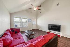 a living room with a red couch and a flat screen tv at Newhouse/Grill/East houston/Channelview/Baytown/Sleeps 8 in Channelview