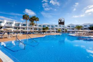 a large swimming pool in front of a hotel at THB Lanzarote Beach in Costa Teguise