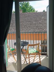 a view of a balcony with a table and chairs at Apartments Vladika - Oldtown in Novi Sad