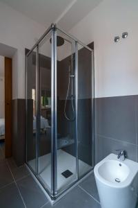 a bathroom with a shower and a toilet and a sink at Camere Cavour in Macerata
