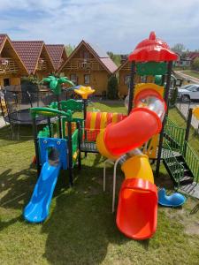 a playground with different colored slides and playset at Złoty Brzeg Wicie in Wicie