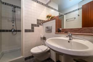 a bathroom with a sink and a toilet and a shower at Hotel Kinsky Fountain in Prague