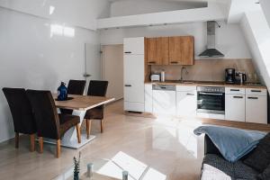 a kitchen and dining room with a table and chairs at Ferienwohnungen Schleicher mit Klimaanlage in Zirndorf +17 photos
